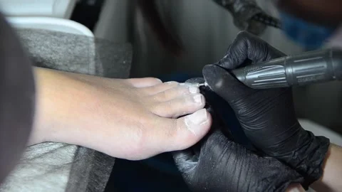 Close Up Professional Pedicure Removing Old Gel Polish with Electric Nail Drill Stock Footage 340820535