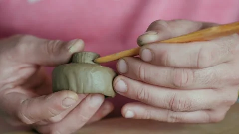 Close-up of a professional potter's hands sculpting a clay bowl Видео 145544280