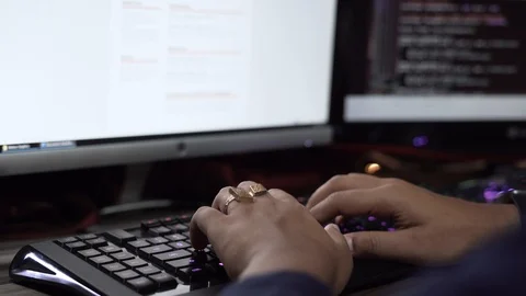 Close up on professional programmer coding, typing on rgb keyboard, Stock Footage 108597298