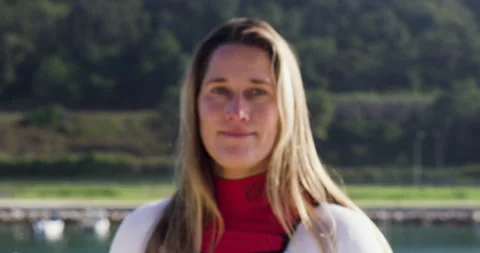 Close up of professional surfer Aline Van Haren in suit smiling at camera Video stock 156625032