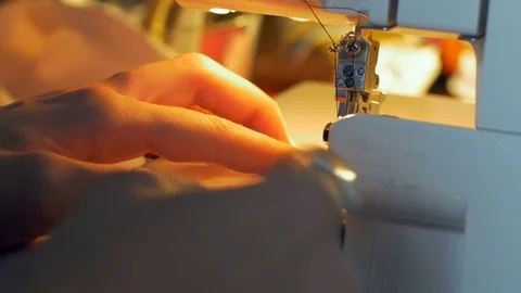 Close-up of professional tailor hands guiding textile in a sewing machine. Stock Footage 80471938