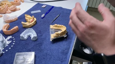 Close Up Of Professional Technician Using Tool To Cut Artificial Dental Model Video stock 232651150