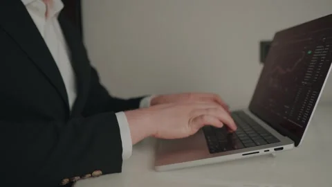 Close-up of professional trader typing on laptop computer with digital trading Видео 317951996