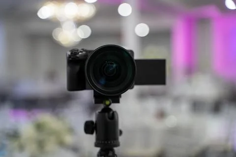 Close up of professional video camera on tripod at event venue Stock Photos
