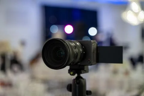 Close up of professional video camera on tripod at event venue Stock Photos