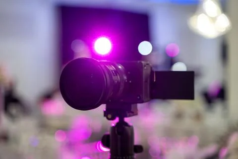 Close up of professional video camera on tripod at event venue Stock Photos