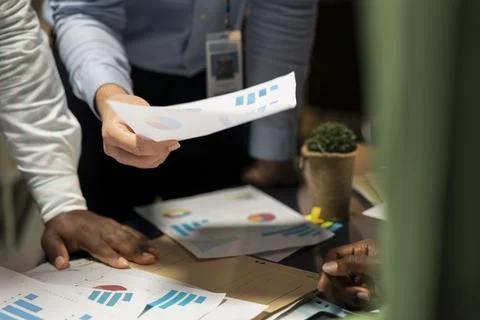 Close up of professionals group evaluating files and performance indicators Stock Photos