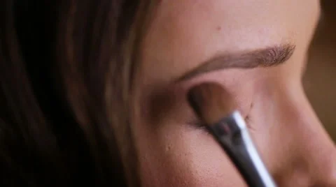 Close up of proffesional make up artist doing make up for a young beautiful lady Stock Footage 61373008