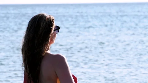 Close-up profile of a Beautiful middle-aged wotan in a red swimsuit Stock Footage 141338830