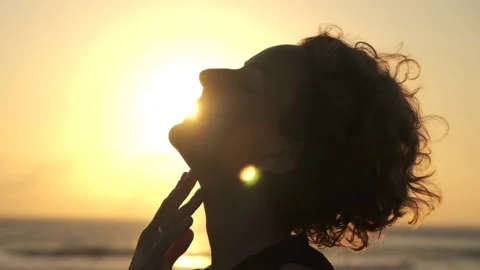 Close-up profile of a beautiful woman's face, she raised her face to the sky Stock Footage 220106408