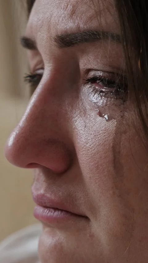 Close up profile of a crying woman's face with tears and mascara running down Stock Footage 342944677