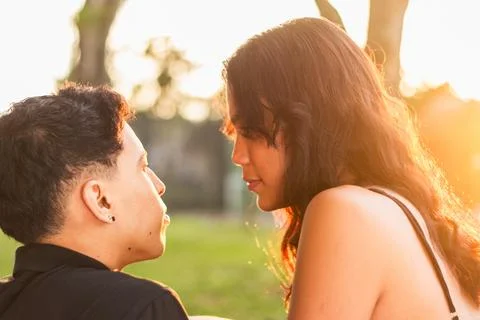 Close-up of the profile of the faces of two young Latinos staring into each.. Stock Photos