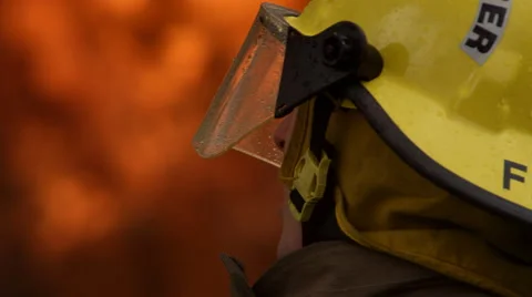 Close-up profile of fireman fighting a fire Stock Footage 59515561