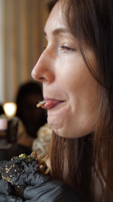 Close up profile of a hungry young brunette woman with freckles wearing black Stock Footage 341580145