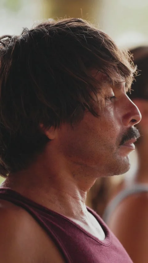 Close-up profile of long-haired man with moustache meditating, eyes closed 動画素材 347633144