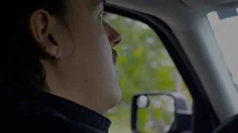 Close-up profile of a man focused on driving a car. Stock Footage 319881339