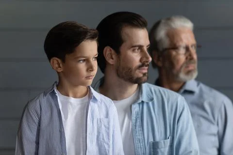 Close up profile three generations of men standing in row Stock Photos