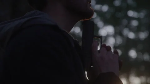 Close up Profile View of Disturbed Man Committing Suicide in Dark Blurred Woods Stock Footage 208798818