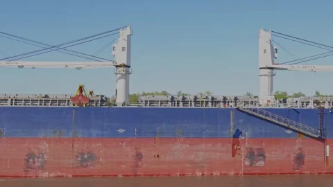 Close-up profile view of a large blue and red bulk carrier cargo ship Stock Footage 345939298