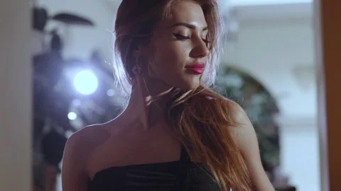 Close up profile view of a pretty young woman with long wavy hair, looking Stock Footage 112674532