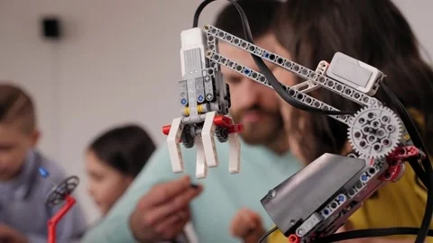 Close-up of programmed robot assembled from plastic parts of a construction kit. 库存影片 150671337