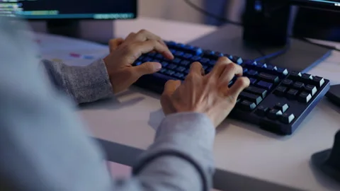 Close-Up of Programmer Coding Late at Night in Modern Office. Stock Footage 300246705