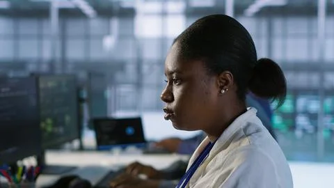 Close up of programmer in data center implementing AI systems Stock Photos