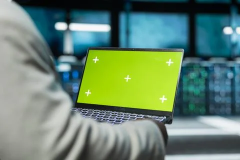 Close up of programmer in data center using green screen laptop Stock-Fotos