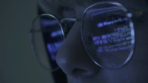 Close up of Programmer hacker working on computer. Code is reflected in his eye  Stock Footage 150426685