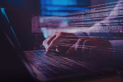 Close up of programmer hands typing code on a laptop with virtual data over.. 스톡 사진