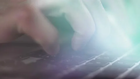 Close-up of a programmer hands typing on a computer keyboard. Beautiful glow of Stock Footage 222433050