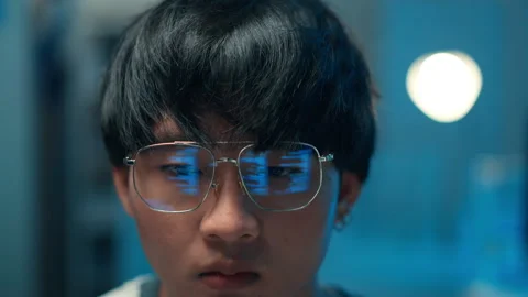 Close-up of programmer reflecting code screen in glasses 動画素材 313807252