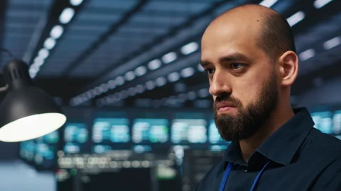 Close up on programmer in server farm safeguarding data Stock Footage 274529049