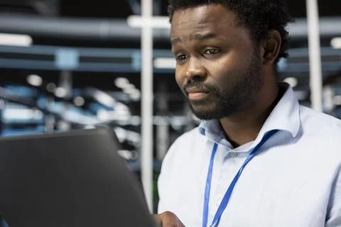 Close up of programmer in server room doing data backup Stock-Fotos
