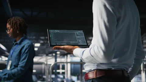Close up of programmer swiping on tablet display in data center, checking code Video stock 310787373