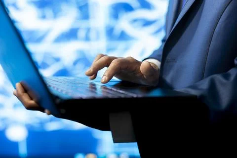 Close up of programmer typing code on laptop, developing AI model Stock Photos