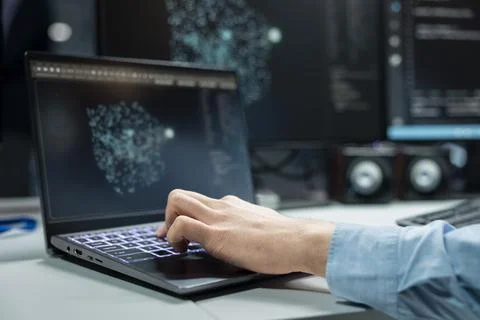 Close up of programmer typing on laptop keyboard, optimizing performance with AI Stock Photos