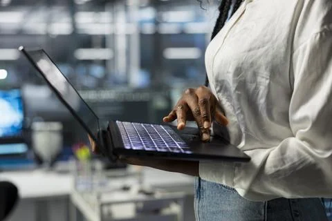 Close up of programmer using laptop in server farm Stock Photos