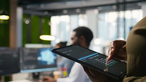 Close up of programmer utilizing AI on tablet to optimize performance Stock Photos
