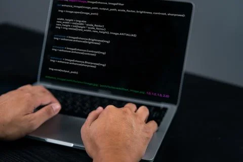 Close-up of a programmer's hands coding on a laptop. Highlights the softwar.. Stock-Fotos