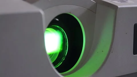 Close up of the projector lens glowing green Video stock 286990849