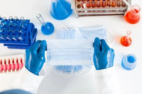 Close up. protective mask in the hands of an epidemiologist. Stock Photos