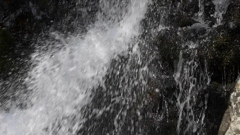 Close pu of slow motion tilt up of a waterfall, Washington State. Video stock 98012032