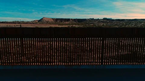 Close up to pull back from the US - Mexico border wall in El Paso Texas Stock Footage 120820376
