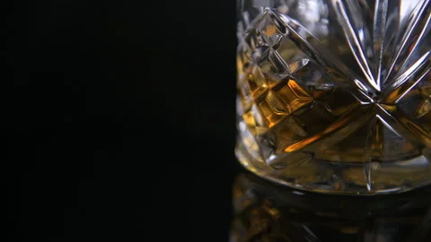 Close Pull Focus From Full Traditional Whiskey Glass Stock Footage 140811127