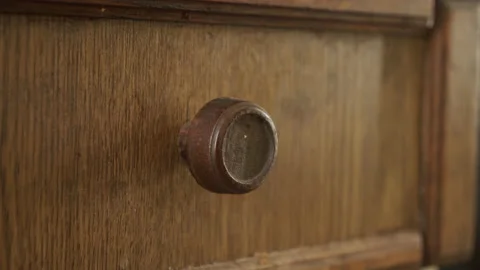 Close-up pulling of old wooden cabinet drawer 4K footage Stock Footage 140695833