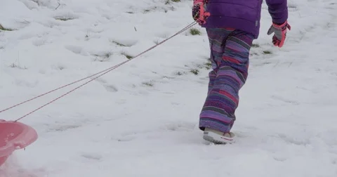 Close up pulling toboggan up hill Stock Footage 70008834