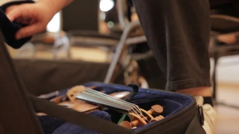 Close up pulling violin out of case Stock Footage