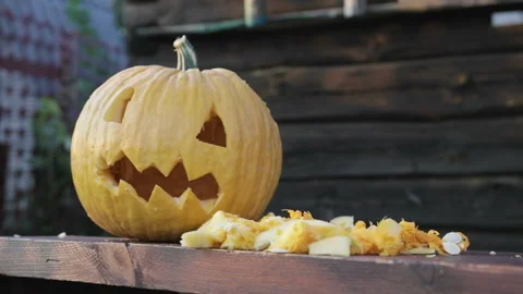 Close-up of a pumpkin and a lantern Jack lying on the table, next to cutting Stock Footage 94936187