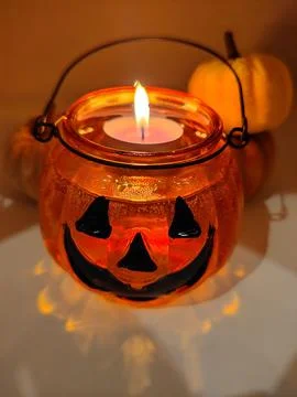 A close-up of a pumpkin candlestick with reflections of light. Halloween Stock Photos